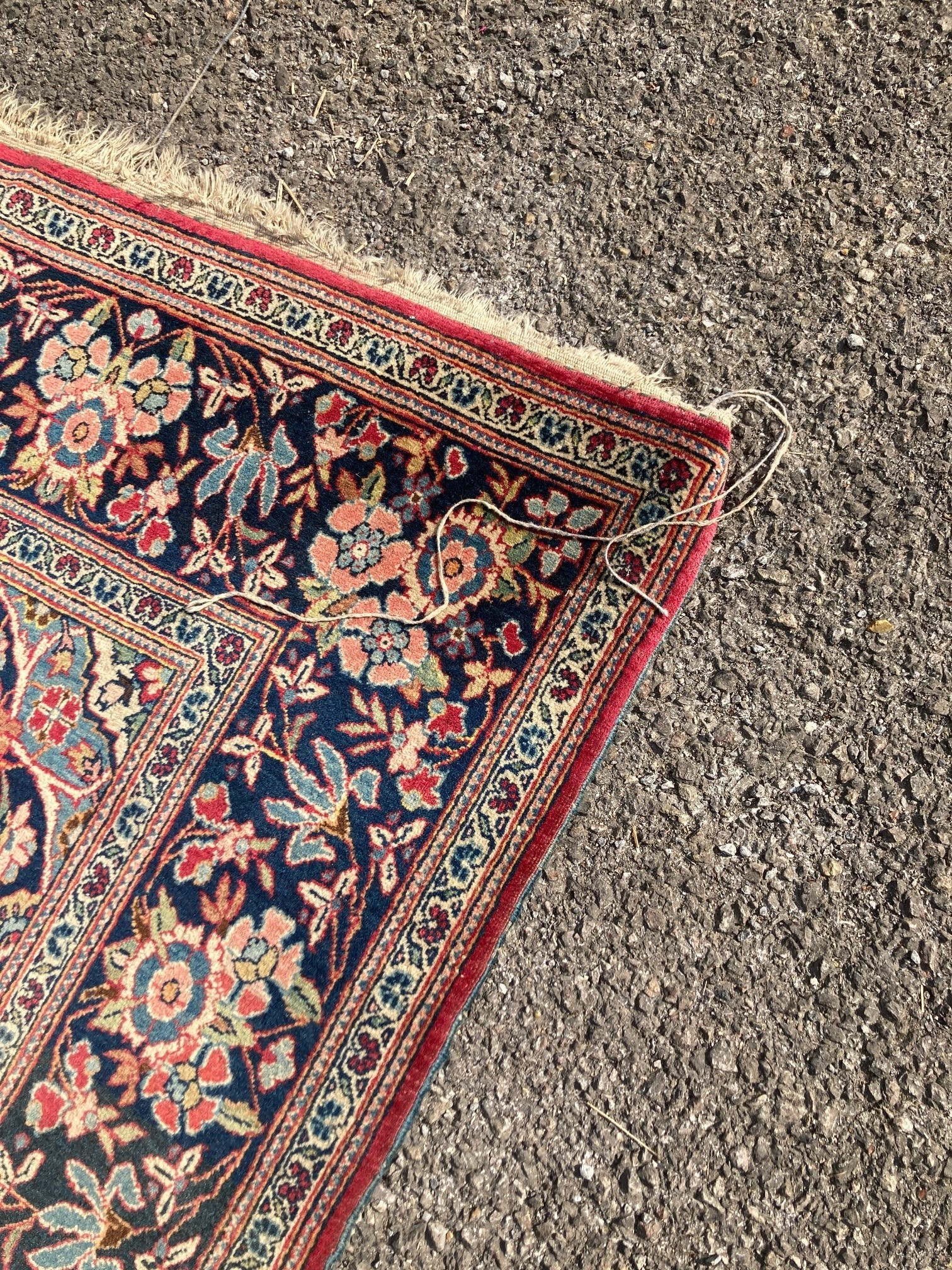 A Kashan red ground rug, with all-over stylised floral motifs